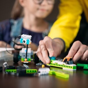 Kids creating robots with teacher. Early development, diy, innov
